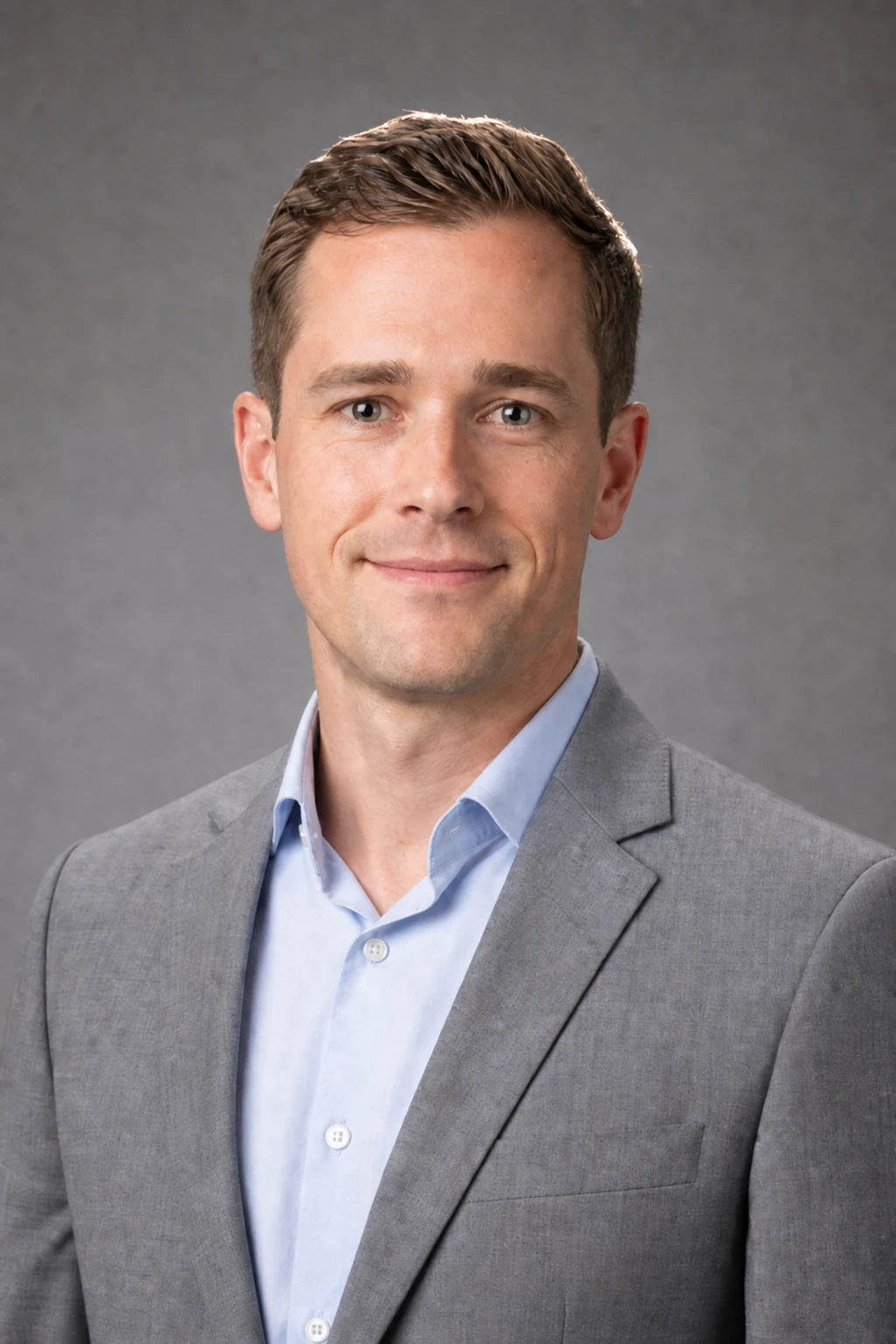 Add a low strip or snoot rim behind the shoulders for separation on dark jackets Portrait subject — Hair Rim Accent variation of Octabox Corporate Headshot.