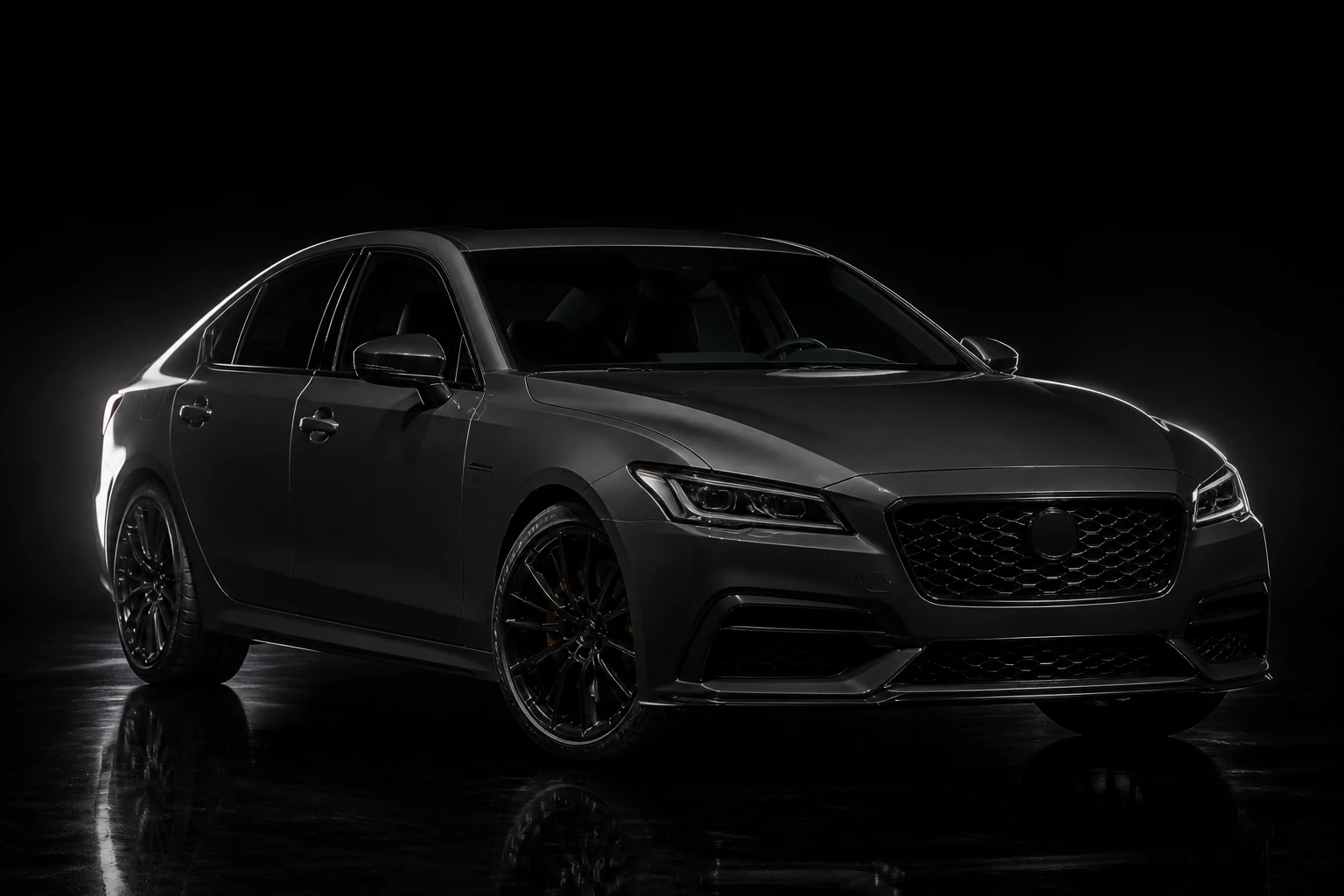 Dark grey sedan at three-quarter front on a black gloss floor, one long soft highlight sweeping the near flank and roofline, the far side dropping into black.