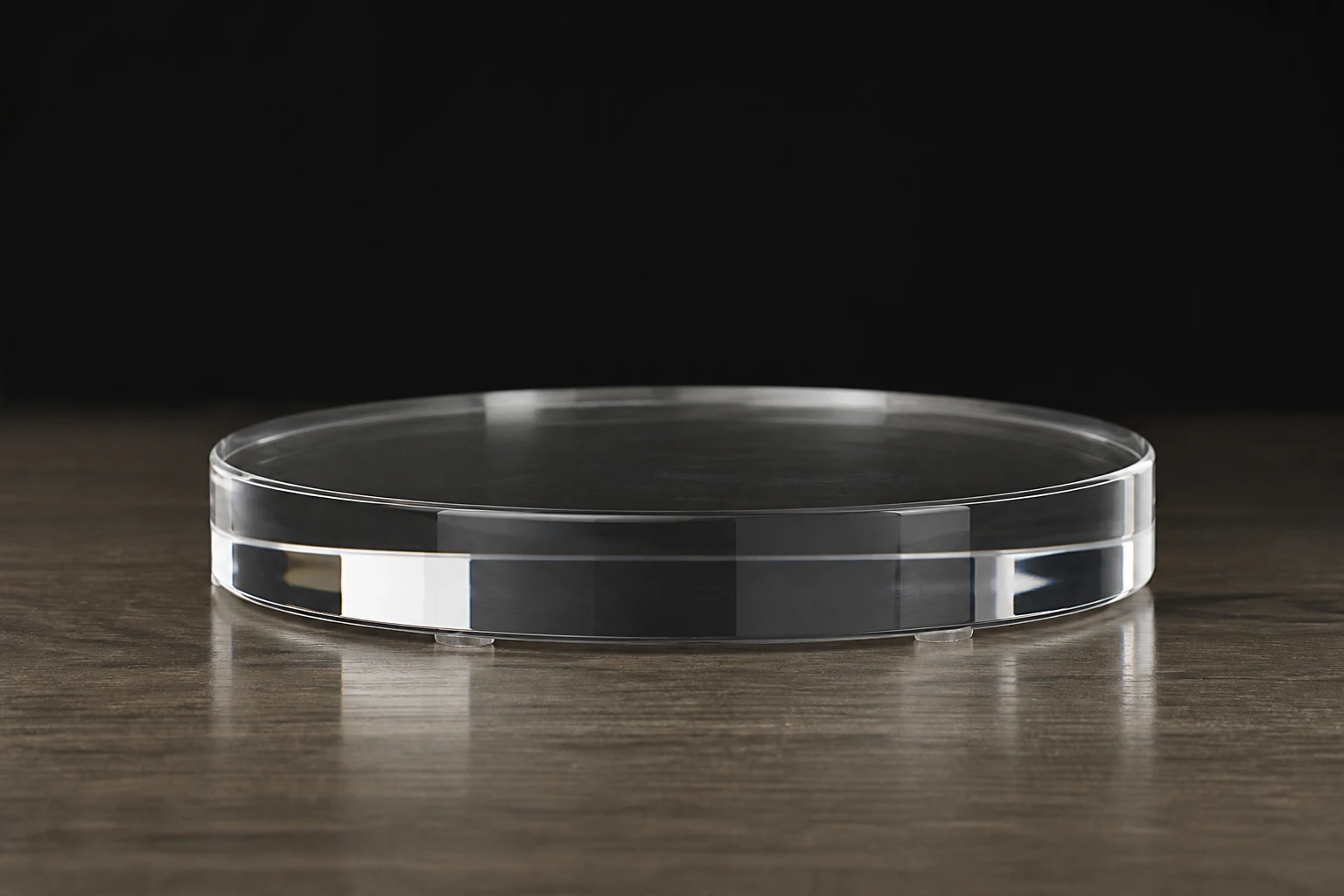 Acrylic / glass base, rigged as it is used — Clear acrylic under product creates a mirror reflection — doubles visual mass and luxury cues