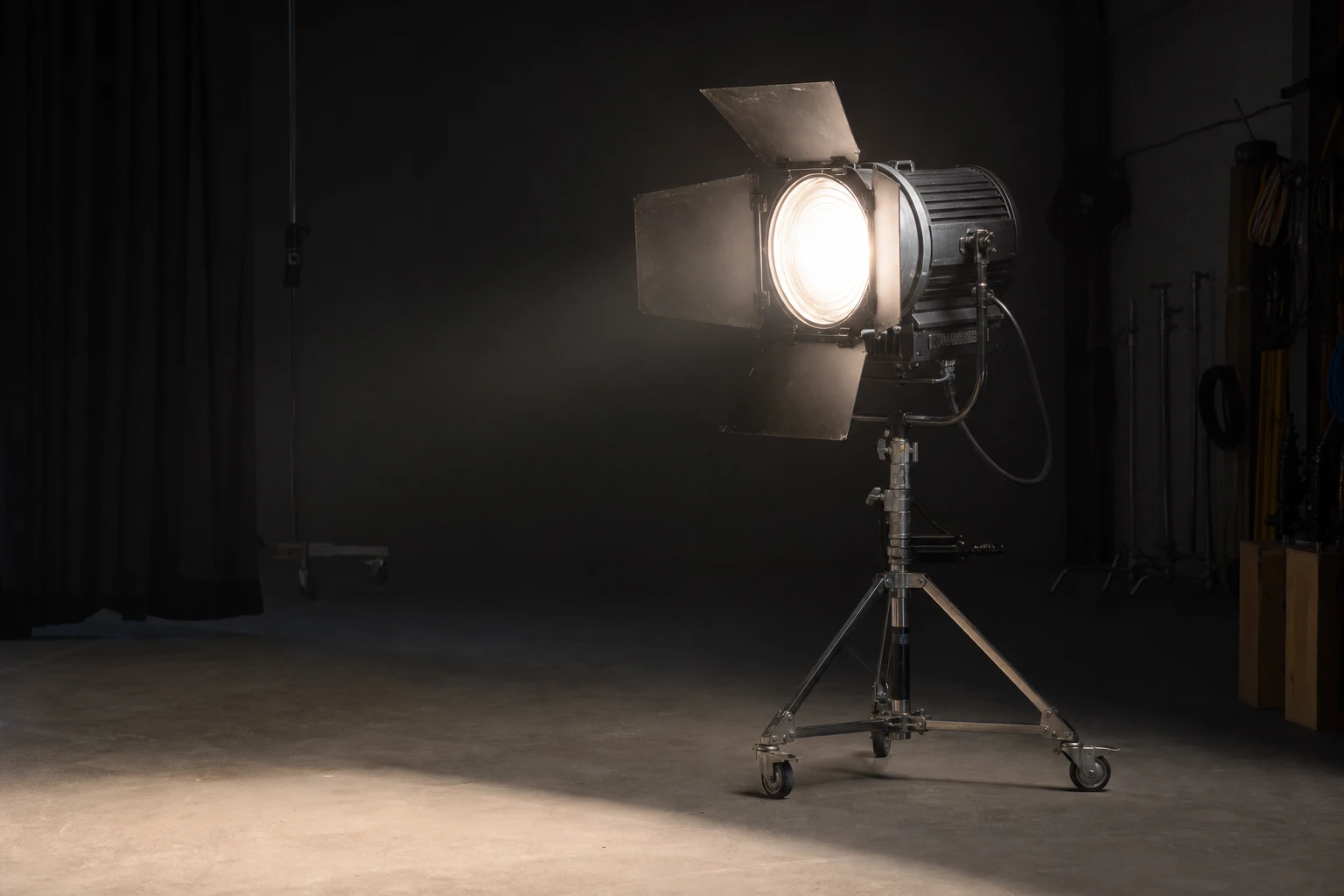 Fresnel, rigged as it is used — A Fresnel lens concentrates flash or continuous light into a focusable beam — the backbone of cinematic “pool of light” portraits and visible shaft…