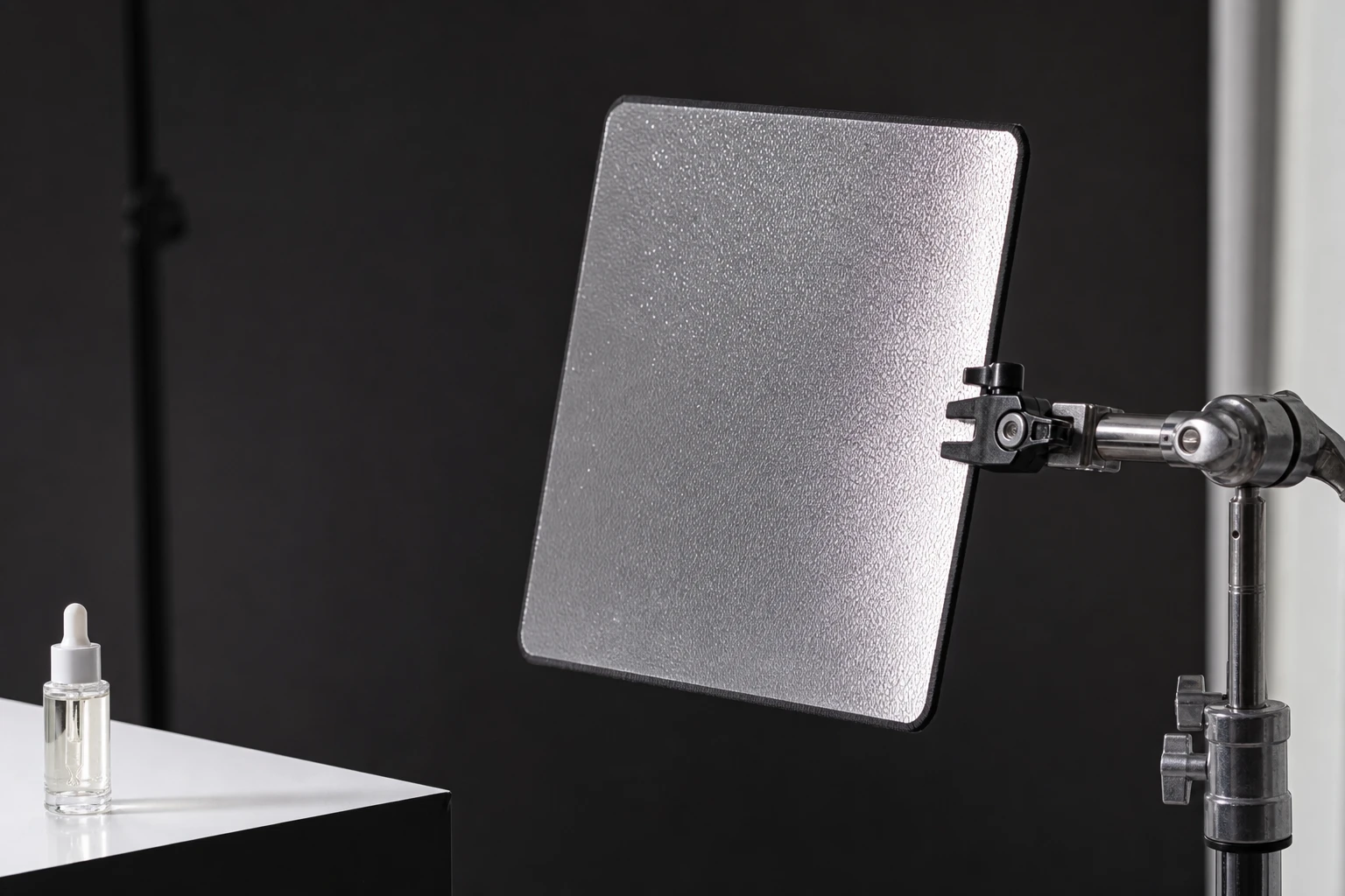 Mirror card, rigged as it is used — A mirror card is a small angled reflector for one specular point on jewelry or metal — precision highlight sculpture