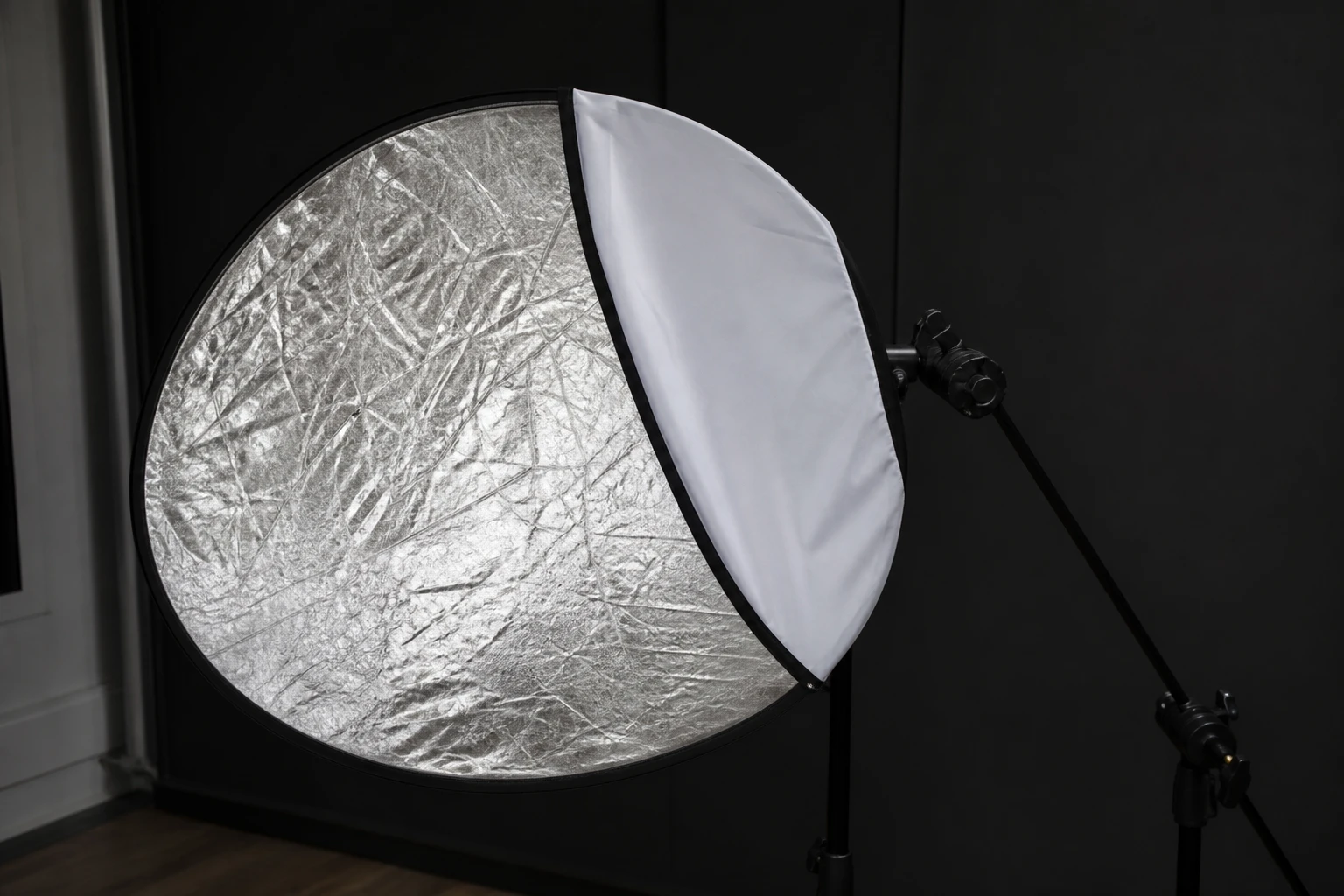 Reflector, rigged as it is used — Reflectors bounce existing light (sun, window, flash spill) back into shadows — no extra power draw