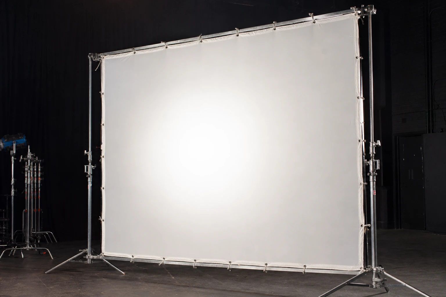 Scrim / diffusion, rigged as it is used — Scrims are diffusion frames — silk, 1/2 stop, 1/4 — placed between sun and subject to enlarge the source